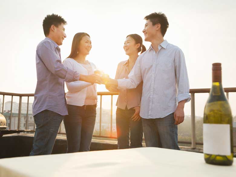 group-of-friends-toasting-each-other-on-rooftop-PM4FTBD-780